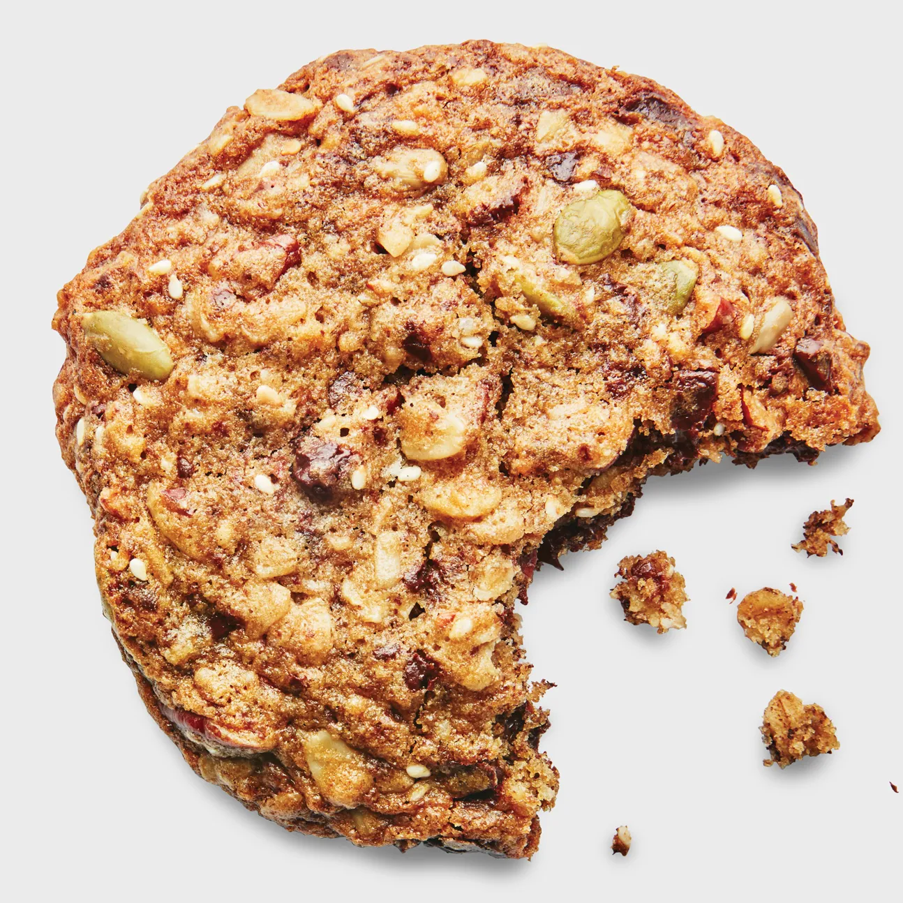 Oat cookie with a bite taken, and a few crumbs