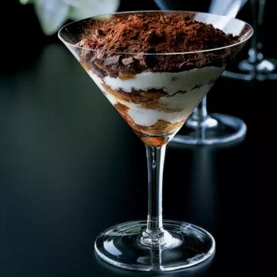Tiramisu served in a martini glass with chocolate sprinkles on top
